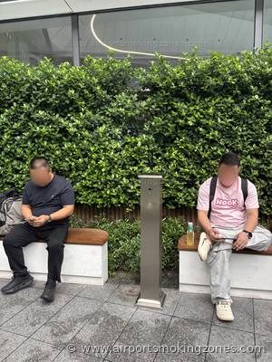 Smoking area at Guangzhou (CAN) airport — Terminal 3, near Gate A838. Outdoor smoking area in the Garden zone (花园). There are benches and…