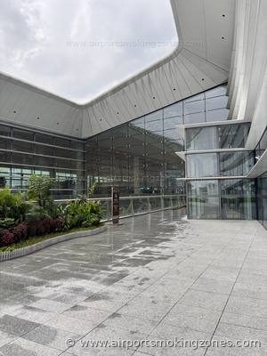 Smoking area at Guangzhou (CAN) airport — Terminal 3, near Gate A838. Outdoor smoking area in the Garden zone (花园). There are benches and…