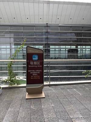 Smoking area at Guangzhou (CAN) airport — Terminal 3, near Gate A838. Outdoor smoking area in the Garden zone (花园). There are benches and…